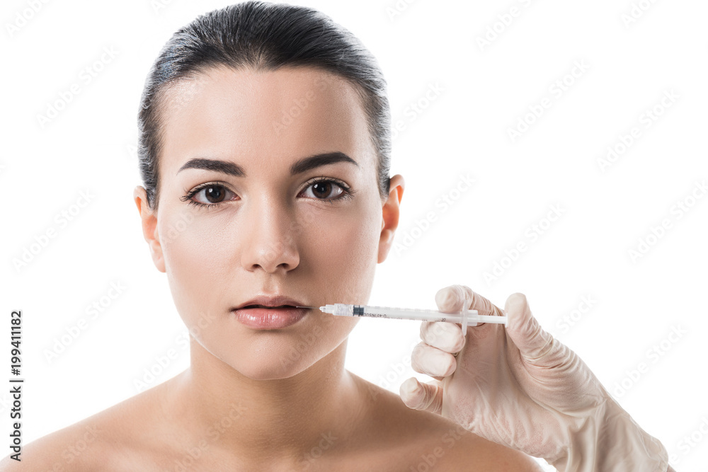 cropped image of cosmetologist making beauty injection in girls lips isolated on white cropped image of cosmetologist making beauty injection in girls lips isolated on white
