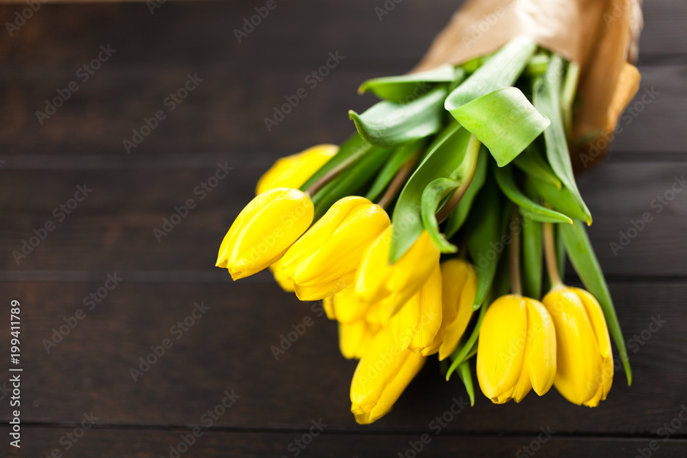 Yellow tulips on wooden background Yellow tulips on wooden background
