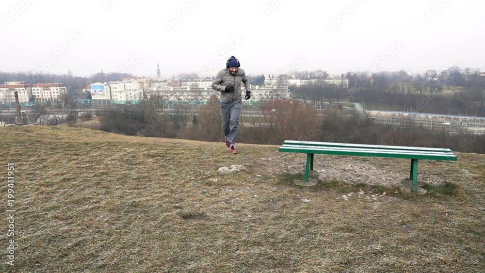 Male jogger running uphill and resting in city park, super slow motion 240fps
Male jogger running uphill and resting in city park, super slow motion 240fps
