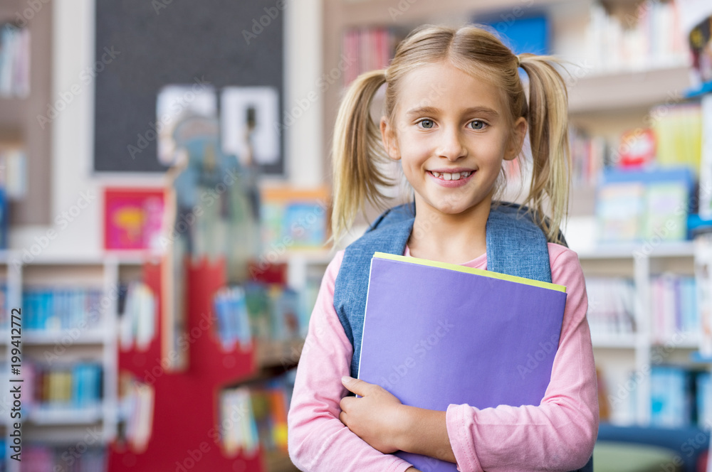 © Rido - Cute school girl holding book © Rido - Cute school girl holding book