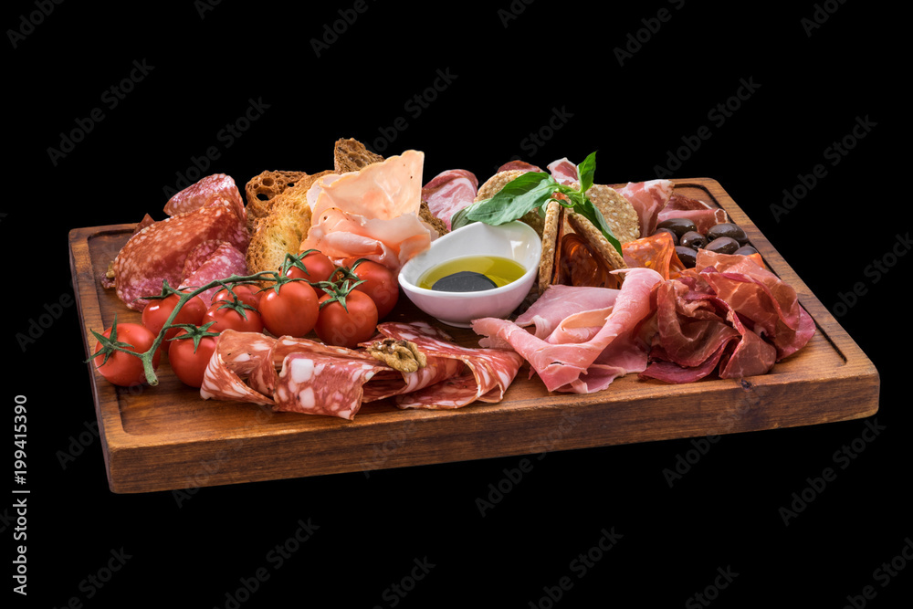tasty plate of cheese, salami, prosciutto, cherry tomatoes over wooden board