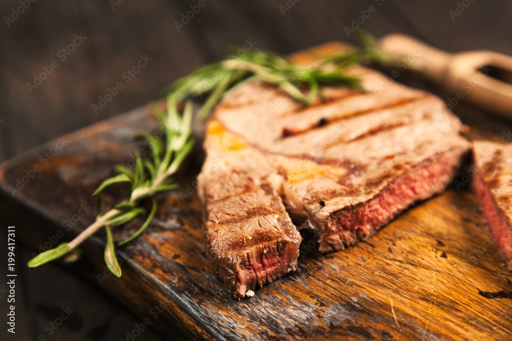 Grilled steak on wooden cutting board Grilled steak on wooden cutting board