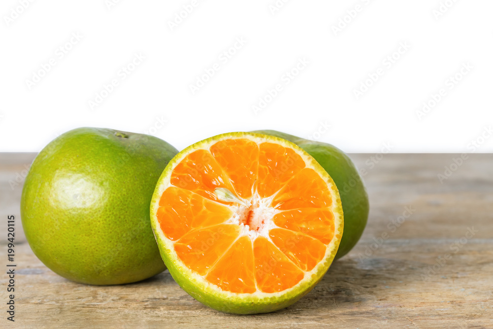 Orange on wooden floor isolated on white background