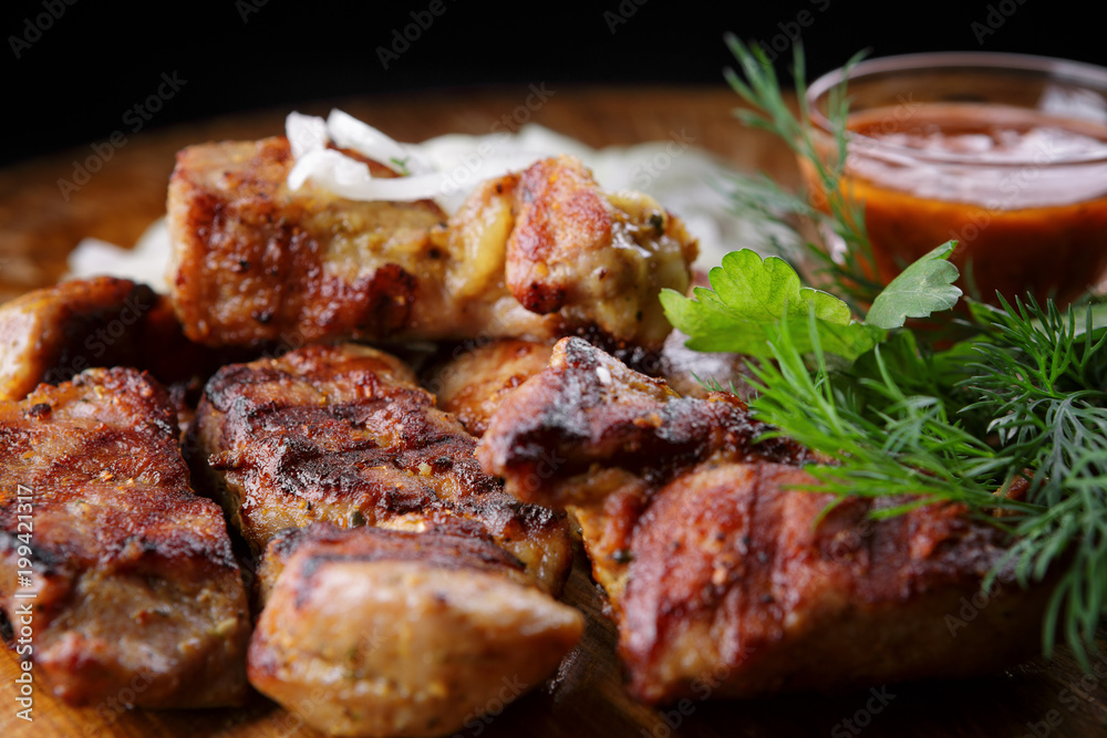 Pork shish kebab with herb sauce and onion