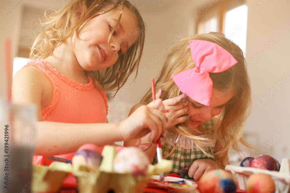 Kids Easter preparation by painting Easter eggs.