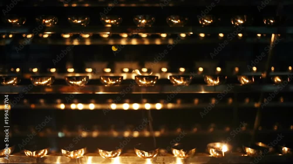 Candle flame close-up. Many Candles in a Buddhist temple. Religious Festival. Oil Lamp