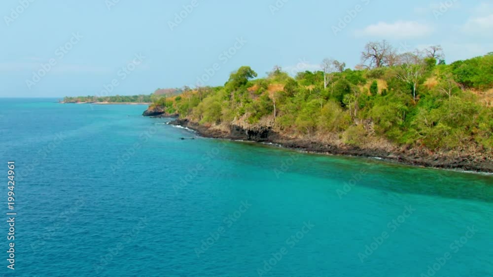 Beautiful scenic establishing shot of a rocky coastline on a sunny day with blue sky Beautiful scenic establishing shot of a rocky coastline on a sunny day with blue sky