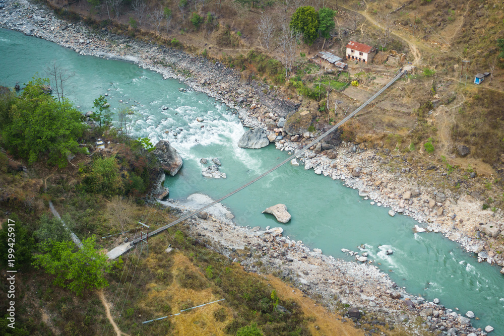 Aerial view of small suspension bridge over the Kali Gandaki river between Kushma and Balewa in Nepal
