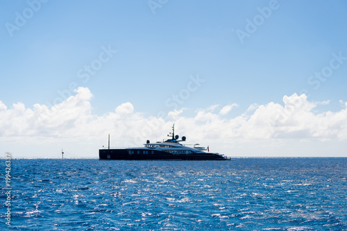 Ship or yacht in sea on blue sky in gustavia, st.barts. Luxury travel on boat and adventure. Vessel and water transport. Summer vacation and holiday destination