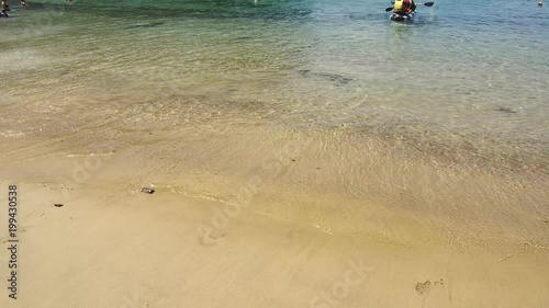 Kayakers in the sea and on the beach in Playa de Papagayo Lanzarote Spain