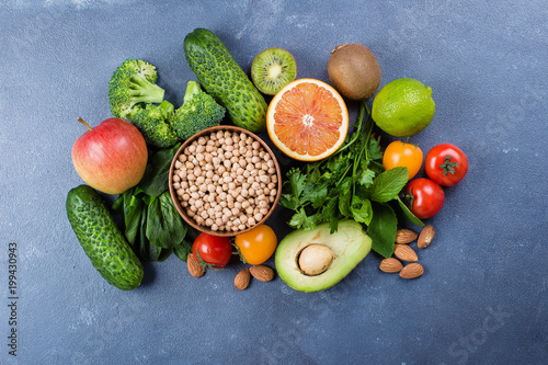 Healthy Food Clean Concept. Raw fruits  Vegetables  Nuts  Cereals on Concrete Stone Table Background.