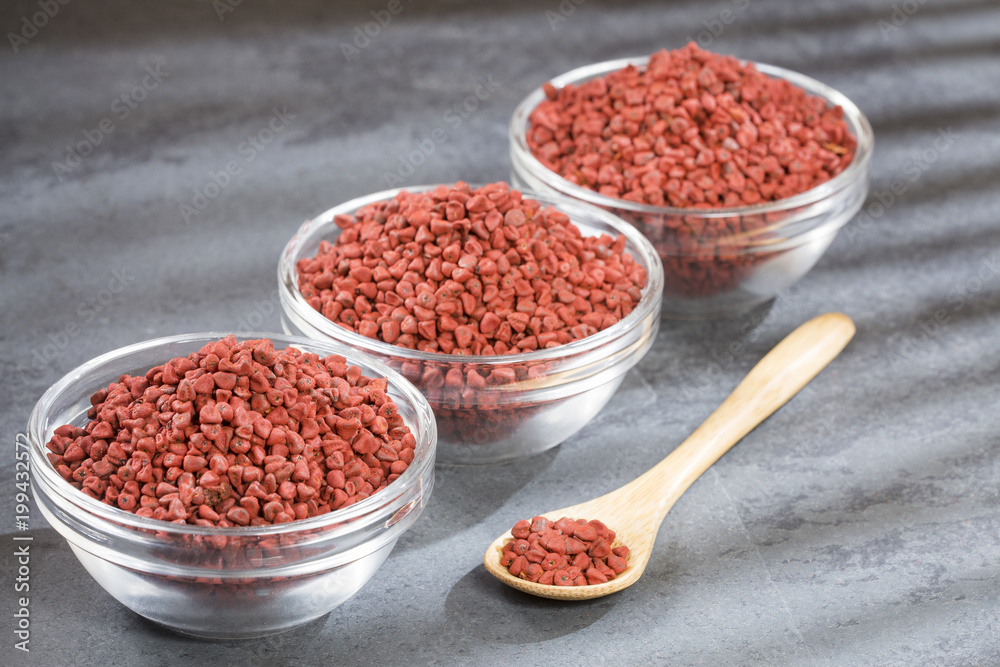 Annatto seeds in the bowls - bixa orellana Annatto seeds in the bowls - bixa orellana