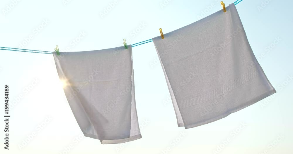 Hanging up the towel for dry under sunset