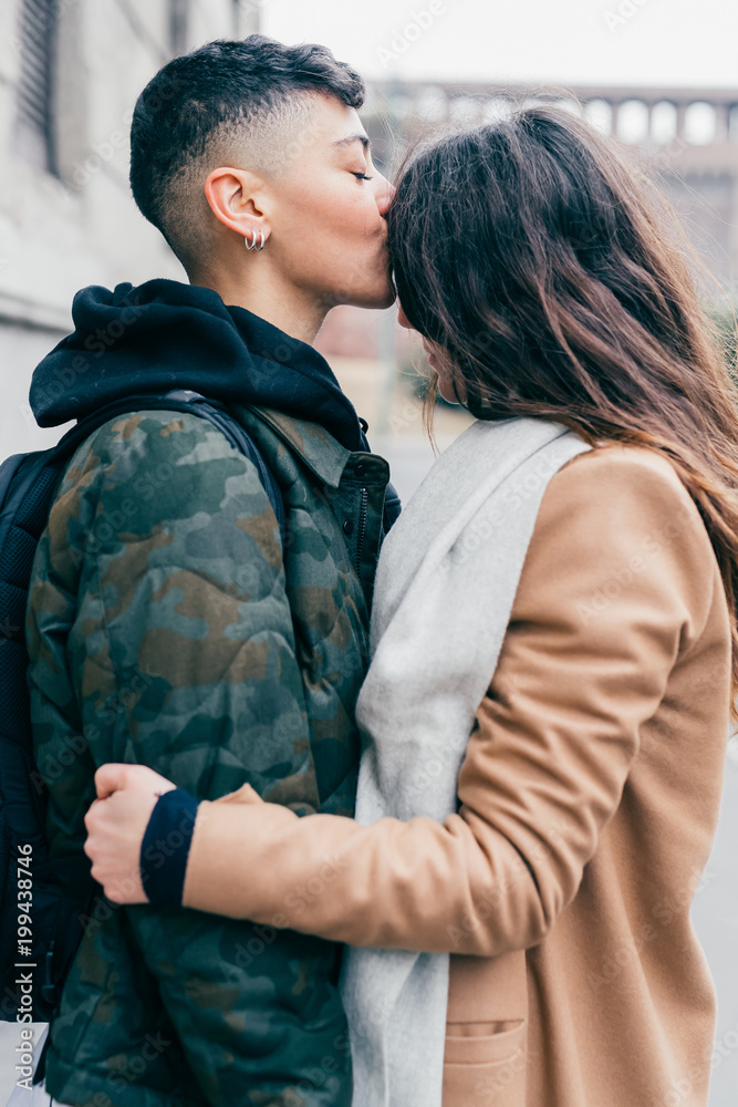 two women lesbian couple outdoors kissing forehead - love, relationship,  couple concept Stock Photo | Adobe Stock