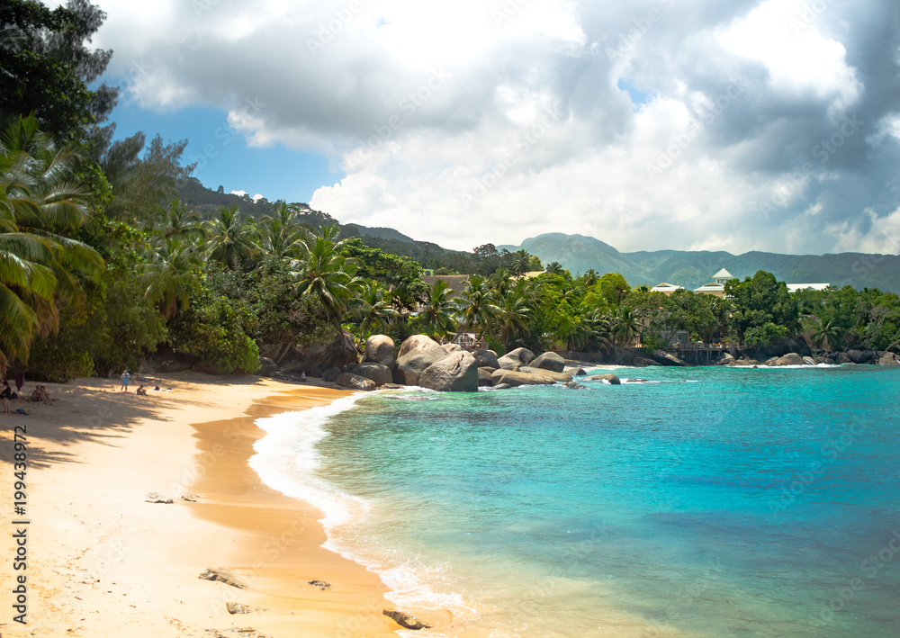 Seychelles Beach with clouds and clear water