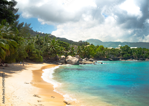 Seychelles Beach with clouds and clear water