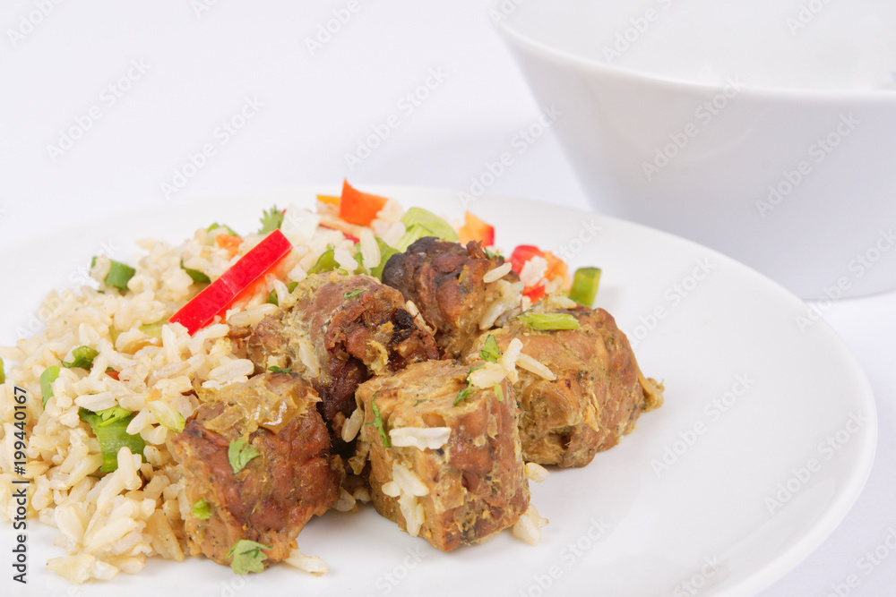 Thai tempeh with coriander and rice on a white Thai tempeh with coriander and rice on a white