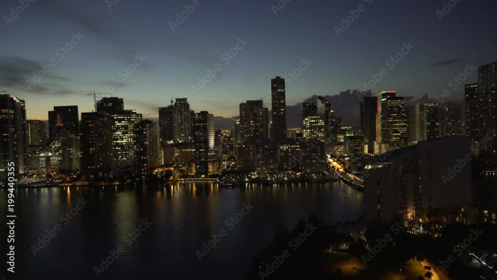Miami aerial view of downtown Miami at night, approaching Brickell Key and the Miami River, featuring buildings and apartments Miami aerial view of downtown Miami at night, approaching Brickell Key and the Miami River, featuring buildings and apartments