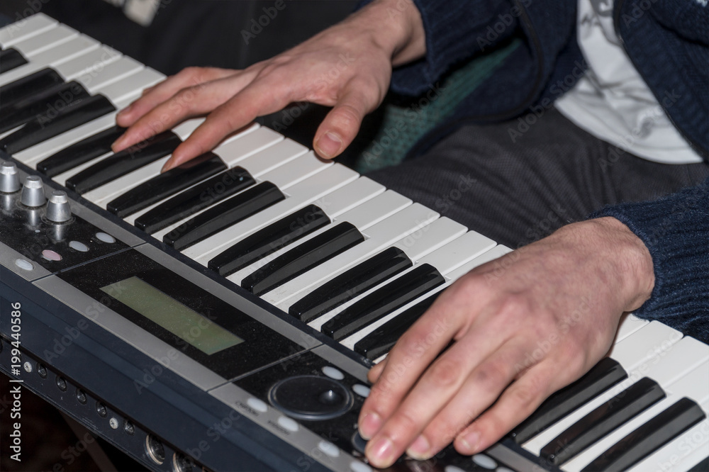 Obraz premium Hands of a pianist. Plays on the synthesizer