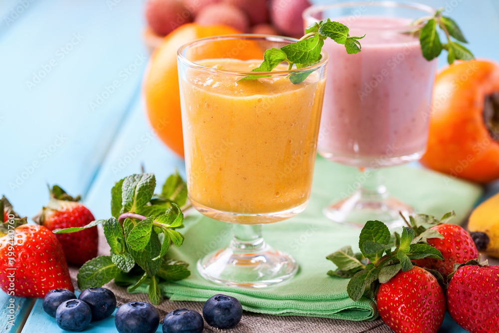 Orange persimmon blueberry smoothie and fruits. Selective focus. Copy space. Top view Orange persimmon blueberry smoothie and fruits. Selective focus. Copy space. Top view