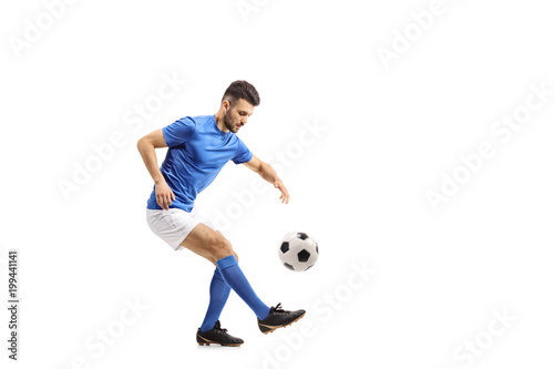 Soccer player juggling a football