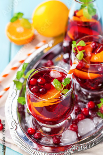 Summer drink Sangria with orange and cranberry. Selective focus. Copy space