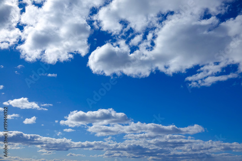 Beautiful blue sky with white fluffy clouds. Texture for background. Copy space for text.