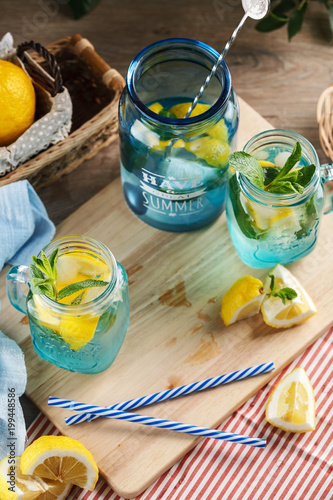 Citrus lemonade water with lemon sliced and mint in blue jar