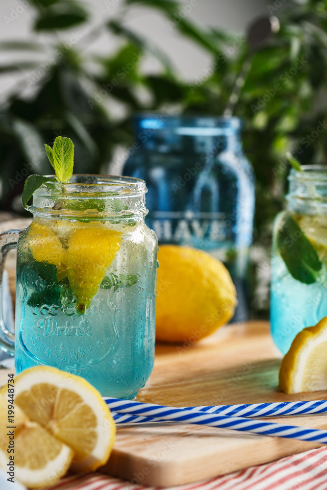 Citrus lemonade water with lemon sliced and mint in blue jar Citrus lemonade water with lemon sliced and mint in blue jar