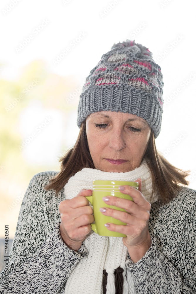 Fototapeta premium Mature woman drinking hot beverage