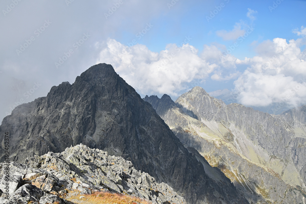 Rocky mountain ridge in foggy clouds Rocky mountain ridge in foggy clouds