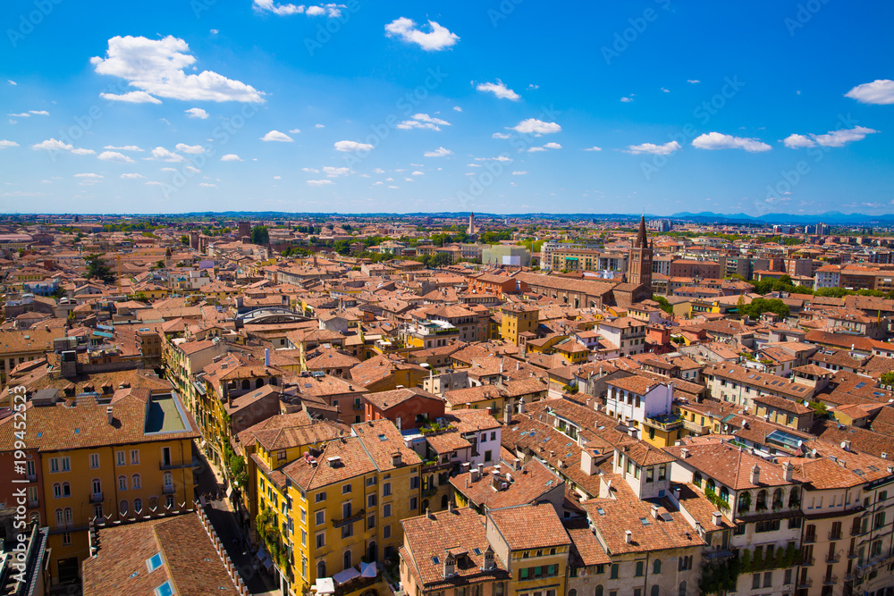 Panoramic cityscape of Verona, Veneto, Italy. Orange tiling  medieval roofs. Bright sunny summer day with blue sky.