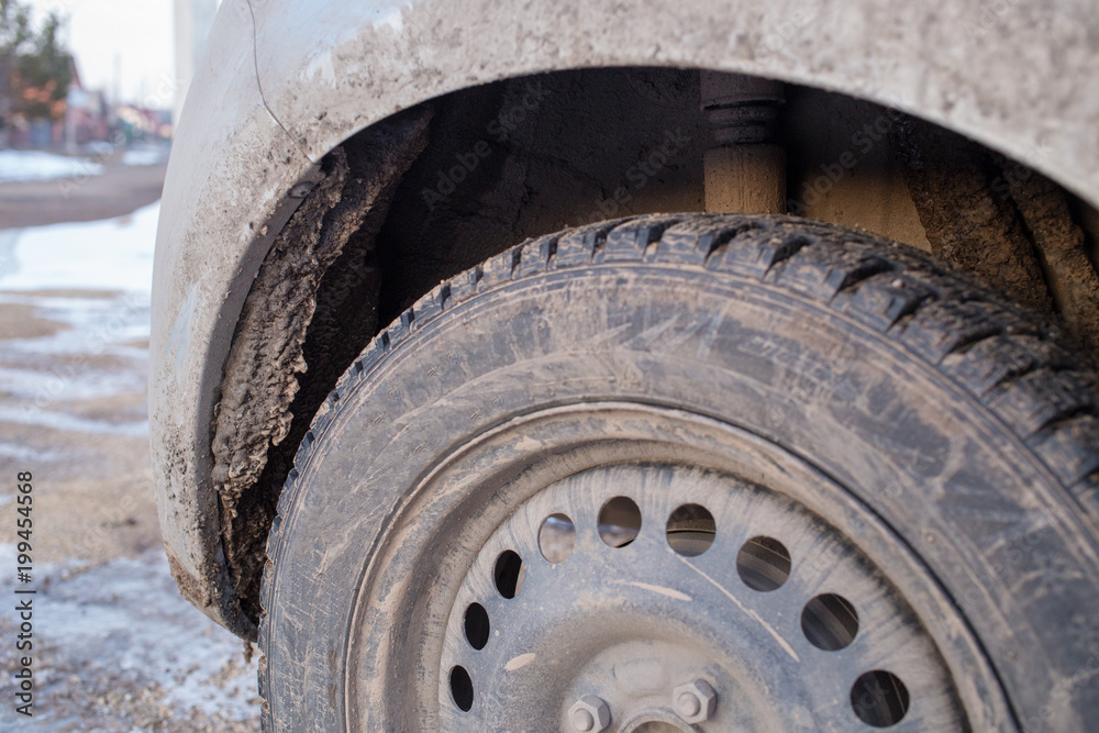 dirty ice under the bumper of the car