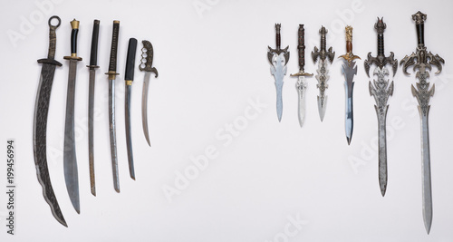 collection of medieval swords, knives and daggers