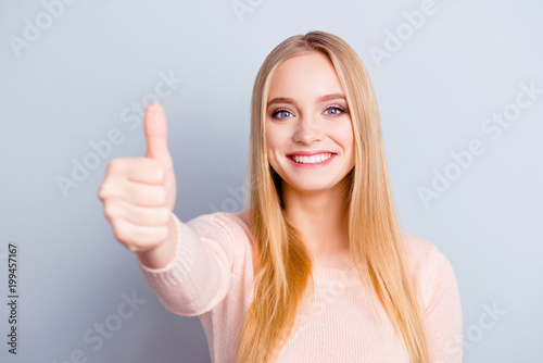 Casual emotion glamour employment perfect excited trendy recommend want person concept. Close up portrait of cheerful cute confident pretty girl demonstrating thumb-up symbol isolated gray background