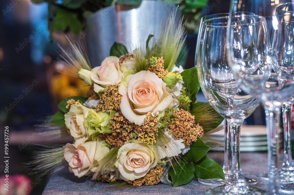 Beautiful flowers on the table with empty wine glasses Beautiful flowers on the table with empty wine glasses