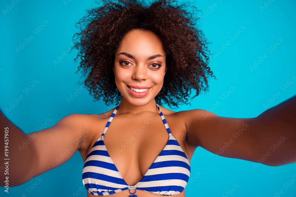 Self photo, portrait of cute lovely nice-looking fresh sexy afro woman with  soft fluffy voluminous curly brown hair, she has video conversation via  internet, isolated on blue background Stock Photo | Adobe