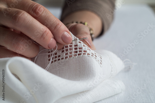 Tableau sur toile Woman's hands embroider ornaments