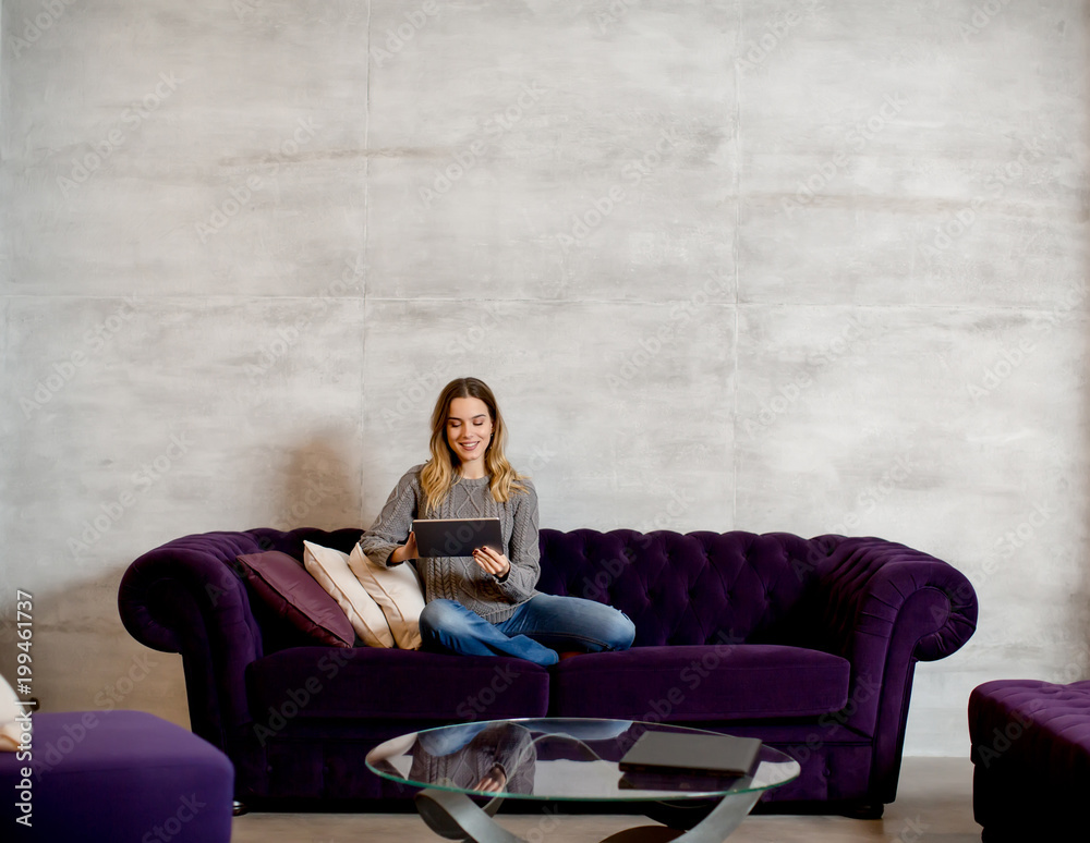 Young woman with tablet on sofa Young woman with tablet on sofa