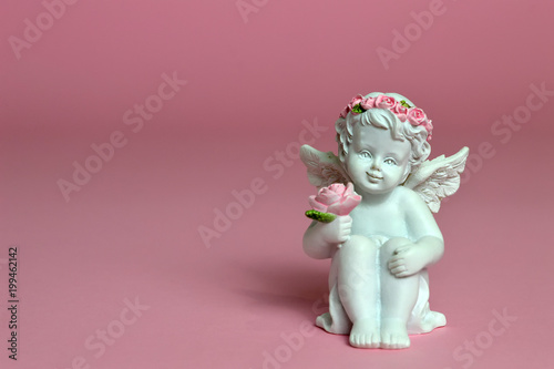 Cherub figurine on pink background