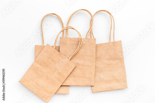 Brown kraft paper bag for shopping on white background top view mockup