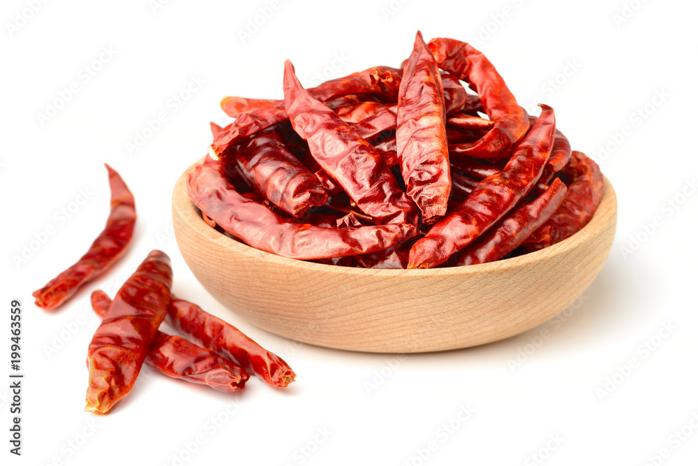dried red chillies in the wooden plate, isolated on white dried red chillies in the wooden plate, isolated on white