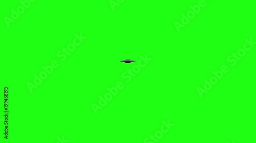 Flying Saucer UFO rotates moving over top of green screen. Moves over and away from camera into the distance green screen