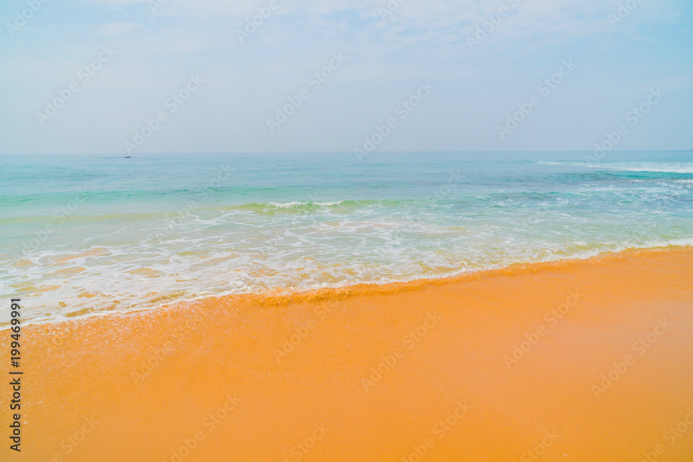 Blue waves of the ocean and yellow sand of the beach. Blue waves of the ocean and yellow sand of the beach.