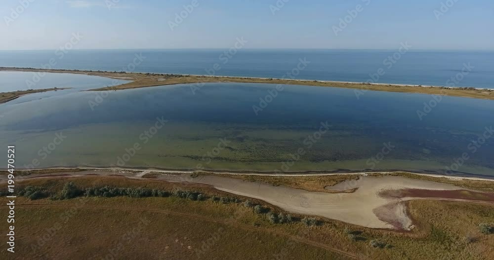 Aerial fantastic view flight of drones over the water of a salt lake on the shore of an island in middle of sea, kinburn foreland Aerial fantastic view flight of drones over the water of a salt lake on the shore of an island in middle of sea, kinburn foreland