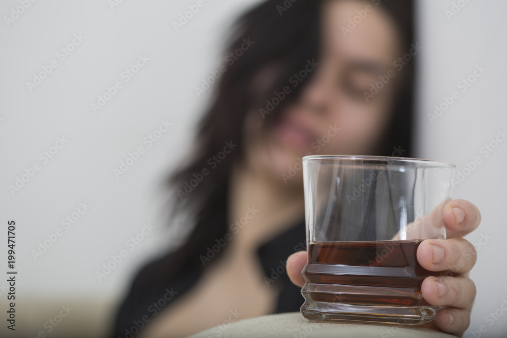 Women holding glass of alcohol drink in interior
