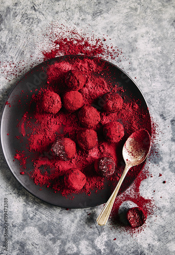 Raw bliss balls: coconut, almonds, coconut oil, vanilla, beetroot powder, coated with beetroot powder and freeze dried raspberry powder. photo