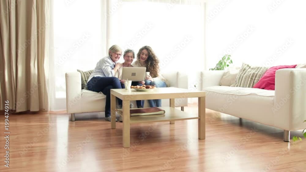 A teenage girl, mother and grandmother with laptop at home. A teenage girl, mother and grandmother with laptop at home.