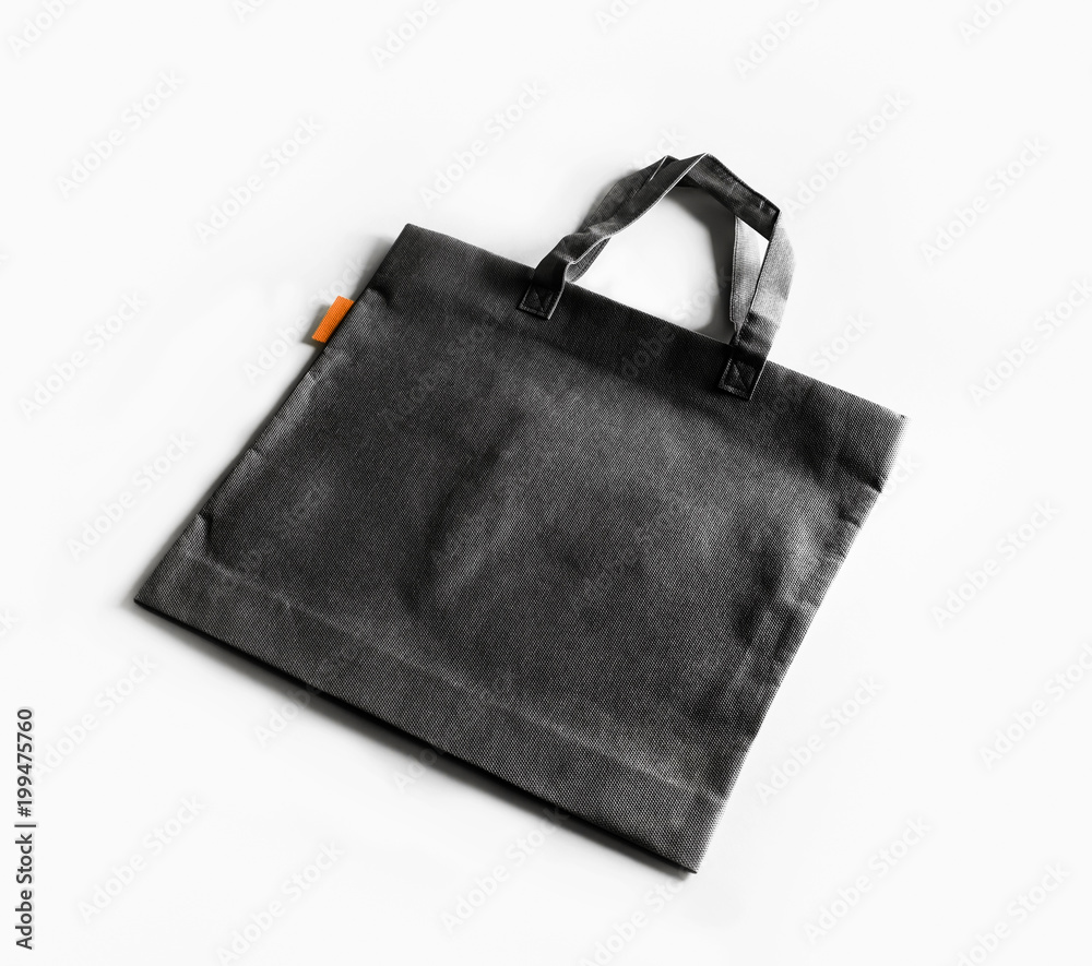 Blank black canvas shopping bag on white paper background. Blank black canvas shopping bag on white paper background.