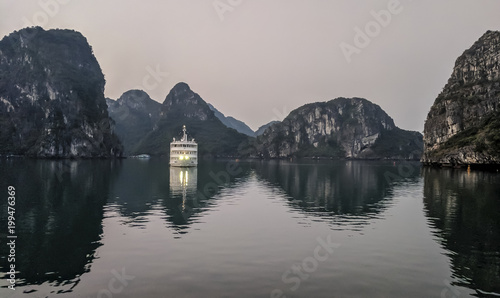 Tourist cruise ship at sunset on Halong Bay, Vietnam